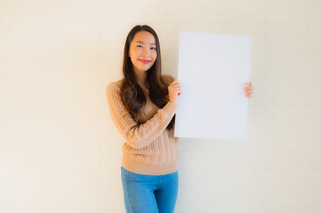 Portrait beautiful young asian woman show blank white paper board