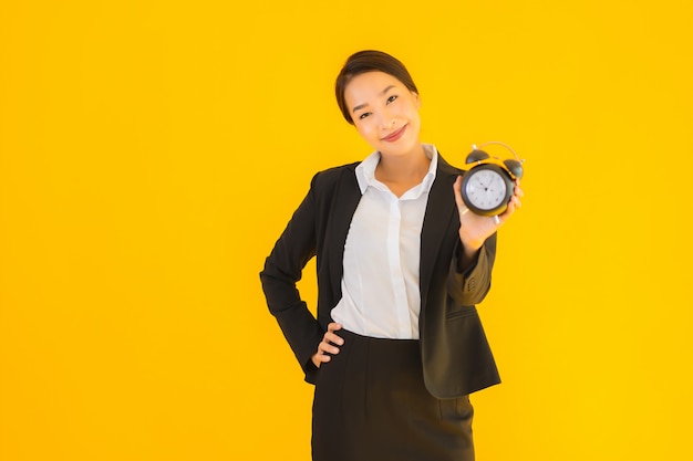 Portrait beautiful young asian woman show clock or alarm