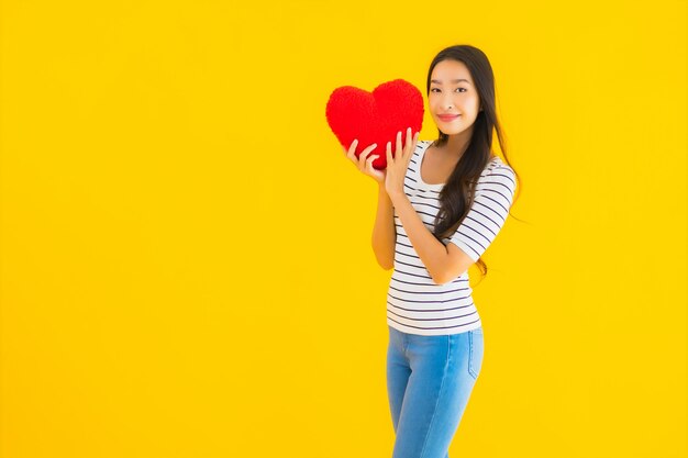 Portrait beautiful young asian woman show heart pillow