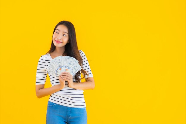 Portrait beautiful young asian woman show a lot of dollar cash or money