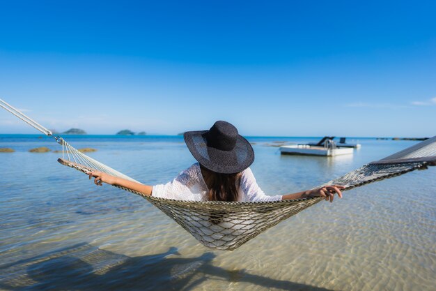 Portrait beautiful young asian woman sitting on hammock around sea beach ocean for relax