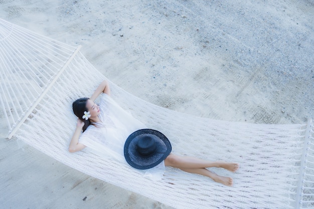 Portrait beautiful young asian woman sitting on hammock around sea beach ocean for relax