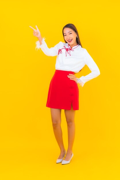 Portrait beautiful young asian woman smile in action on yellow