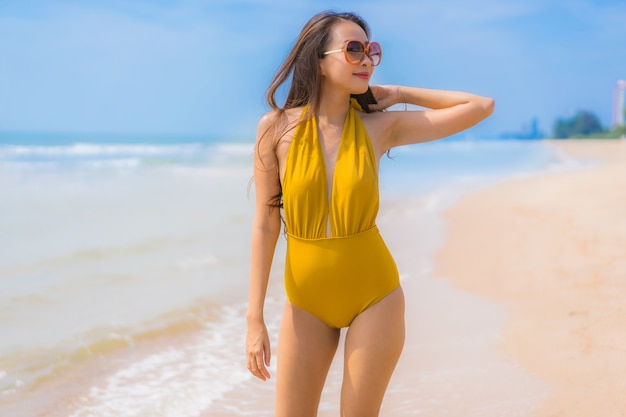 Portrait beautiful young asian woman smile happy on the beach and sea