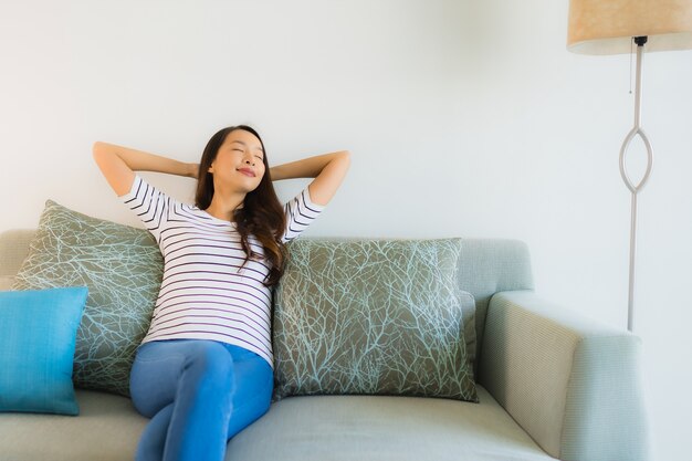 Portrait beautiful young asian woman smile happy on sofa