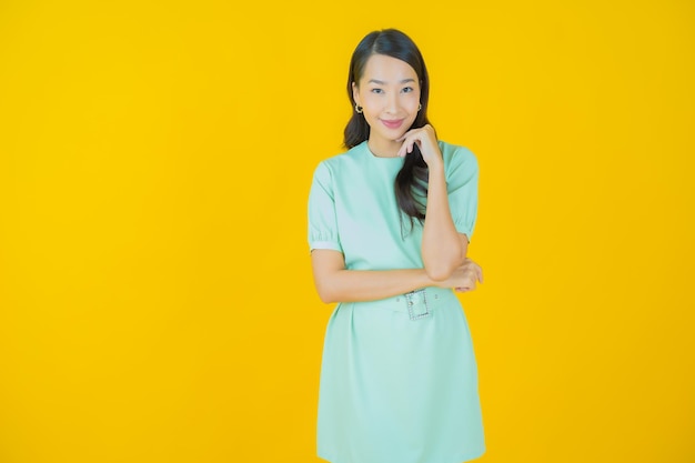 Portrait beautiful young asian woman smile with action on color background