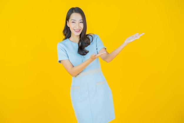 Portrait beautiful young asian woman smile with action on color background