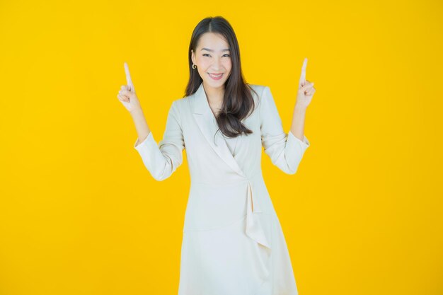 Portrait beautiful young asian woman smile with action on color background