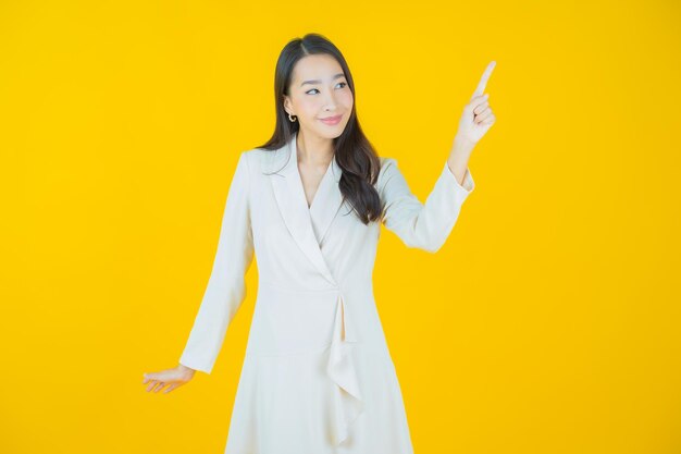 Portrait beautiful young asian woman smile with action on color background