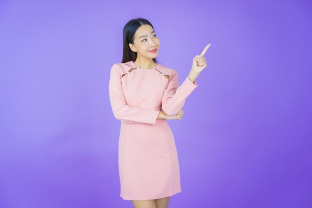 Portrait beautiful young asian woman smile with action on color background