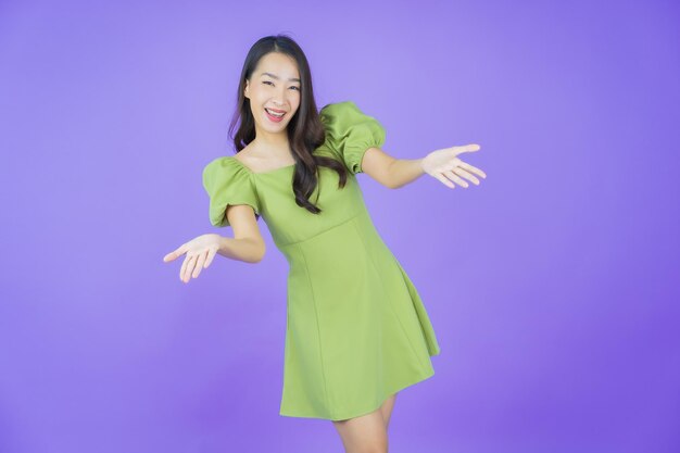 Portrait beautiful young asian woman smile with action on color background