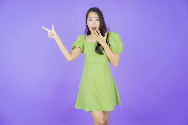 Portrait beautiful young asian woman smile with action on color background