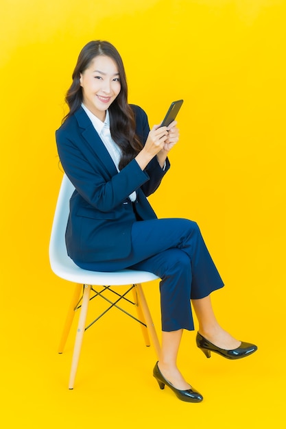 Portrait beautiful young asian woman smile with action on yellow