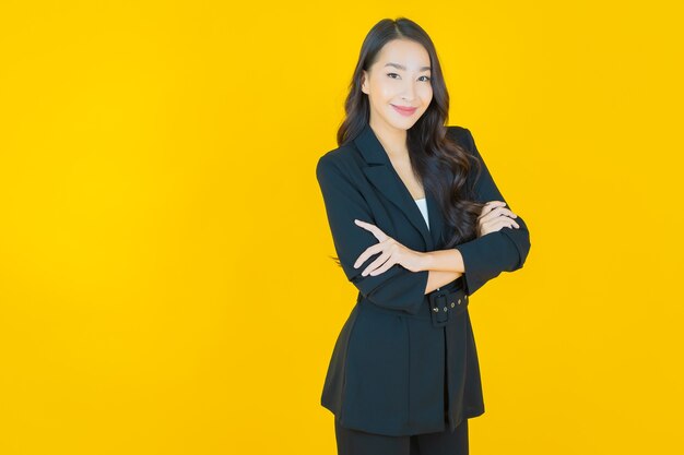 Portrait beautiful young asian woman smile with action on yellow