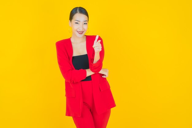 Portrait beautiful young asian woman smile with action on yellow