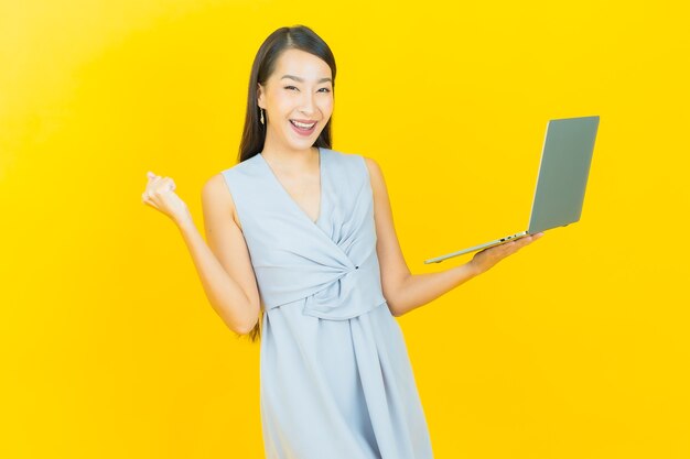 Portrait beautiful young asian woman smile with computer laptop on isolated background