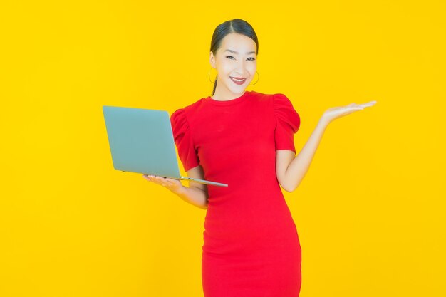 Portrait beautiful young asian woman smile with computer laptop on isolated background