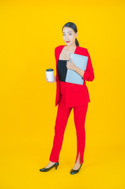 Portrait beautiful young asian woman smile with computer laptop on isolated background