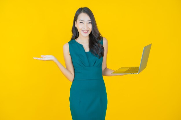 Portrait beautiful young asian woman smile with computer laptop on isolated background