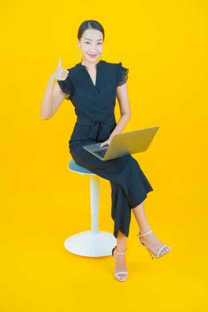 Portrait beautiful young asian woman smile with computer laptop on isolated background