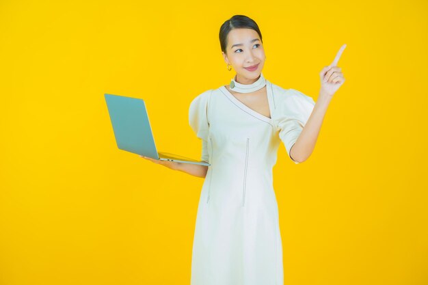 Portrait beautiful young asian woman smile with computer laptop on isolated background