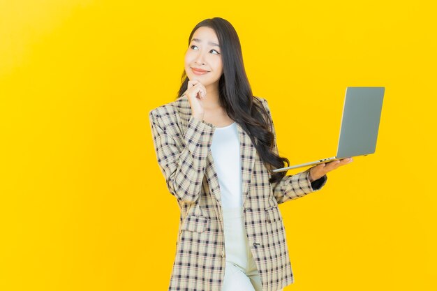 Portrait beautiful young asian woman smile with computer laptop