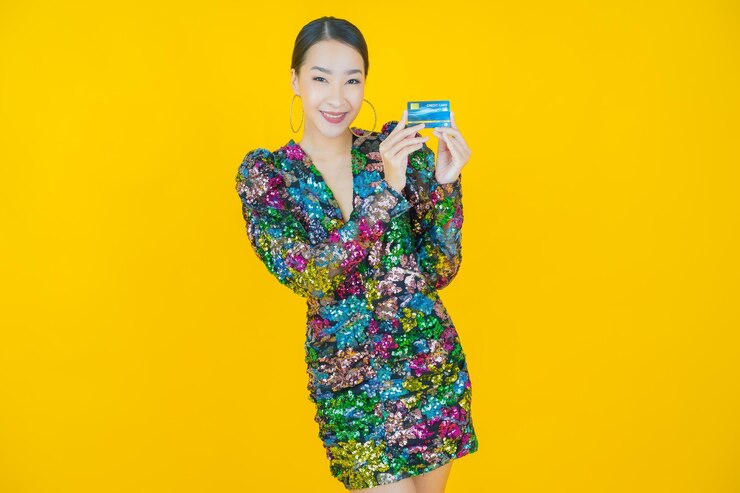 Free Photo portrait beautiful young asian woman smile with credit card on yellow