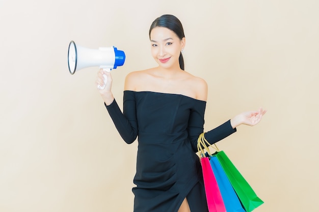 Free Photo portrait beautiful young asian woman smile with megaphone on yellow