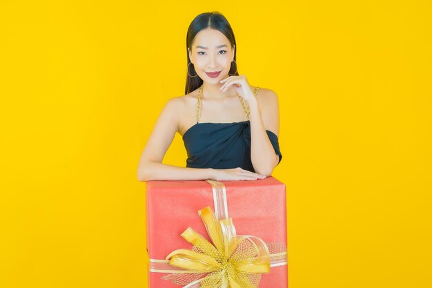 Portrait of beautiful  young asian woman smile with red gift box  