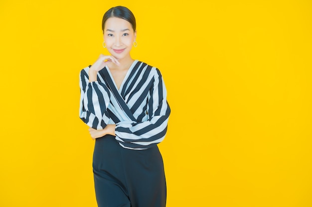 Portrait beautiful young asian woman smile on yellow