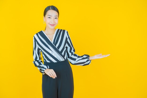 Portrait beautiful young asian woman smile on yellow