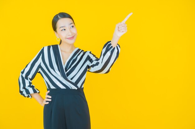 Portrait beautiful young asian woman smile on yellow