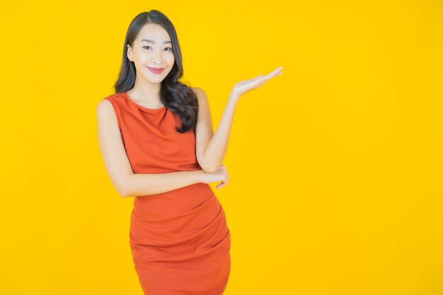 Portrait beautiful young asian woman smile on yellow