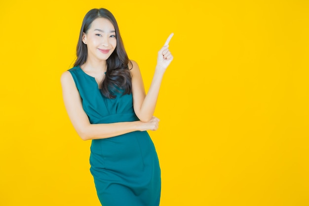 Portrait beautiful young asian woman smile on yellow