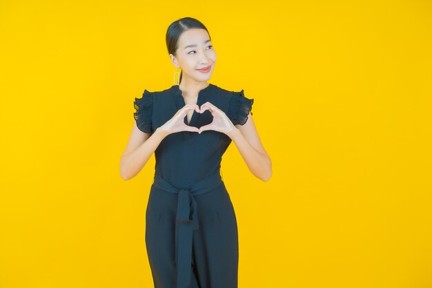 Portrait beautiful young asian woman smile on yellow