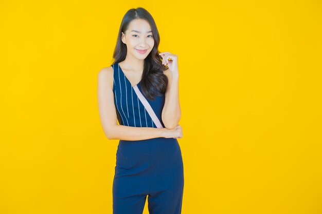 Portrait beautiful young asian woman smile on yellow