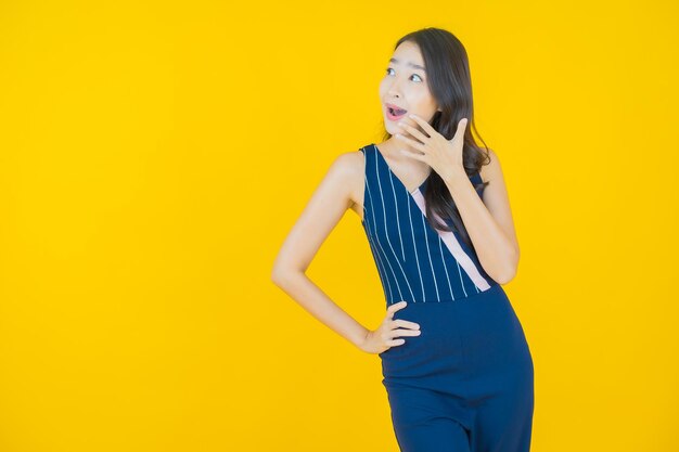 Portrait beautiful young asian woman smile on yellow