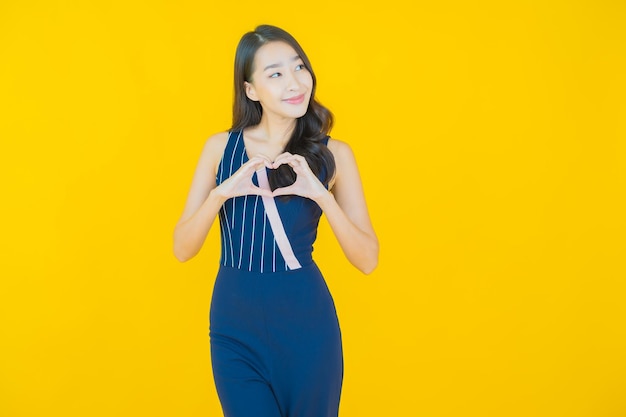 Portrait beautiful young asian woman smile on yellow