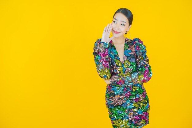 Portrait beautiful young asian woman smile on yellow