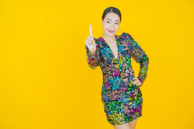 Portrait beautiful young asian woman smile on yellow