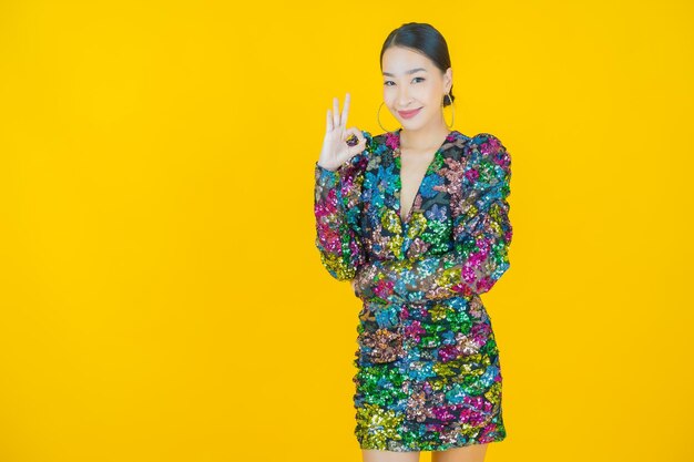 Portrait beautiful young asian woman smile on yellow