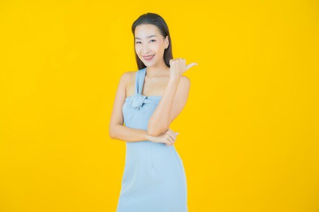 Portrait beautiful young asian woman smile on yellow