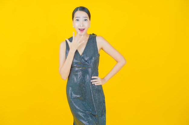 Portrait beautiful young asian woman smile on yellow