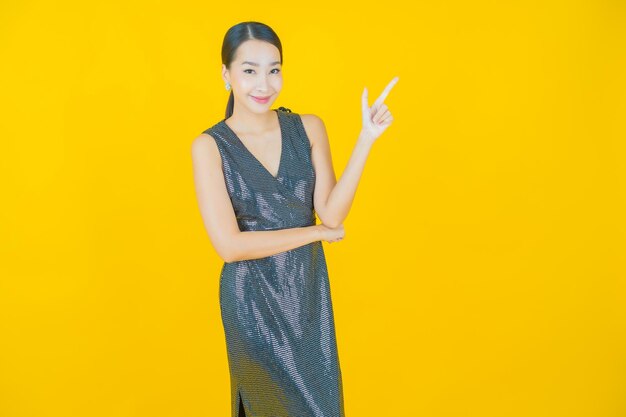 Portrait beautiful young asian woman smile on yellow