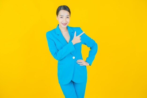 Portrait beautiful young asian woman smile on yellow