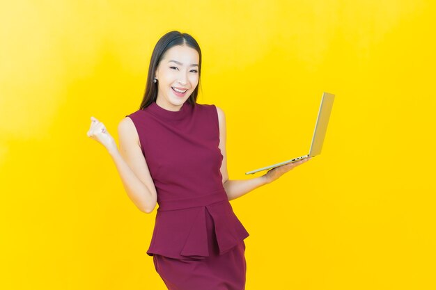 Portrait beautiful young asian woman smiles with computer laptop on isolated background