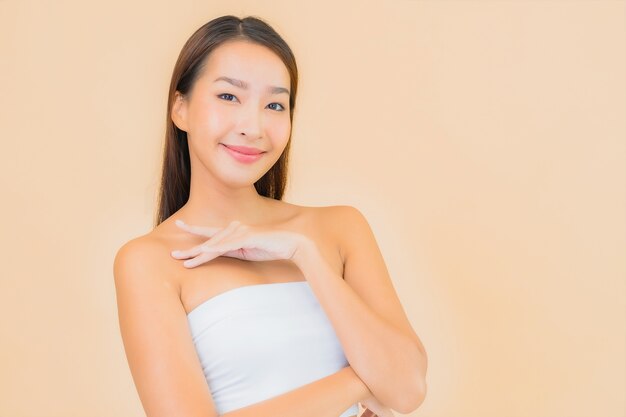 Portrait beautiful young asian woman in spa with natural make up on beige