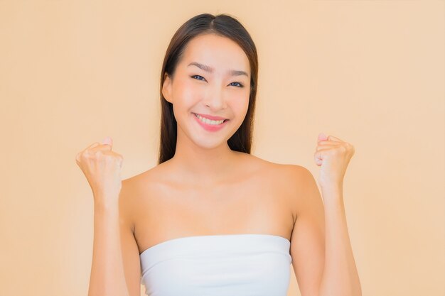 Portrait beautiful young asian woman in spa with natural make up on beige