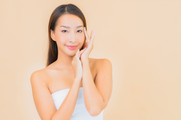 Portrait beautiful young asian woman in spa with natural makeup on beige