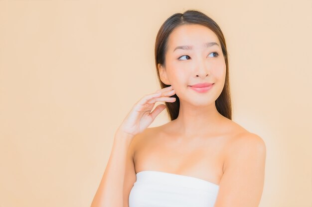 Portrait beautiful young asian woman in spa with natural makeup on beige